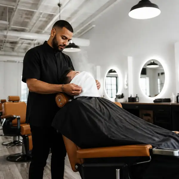 Hot towel shave in a cognac leather chair