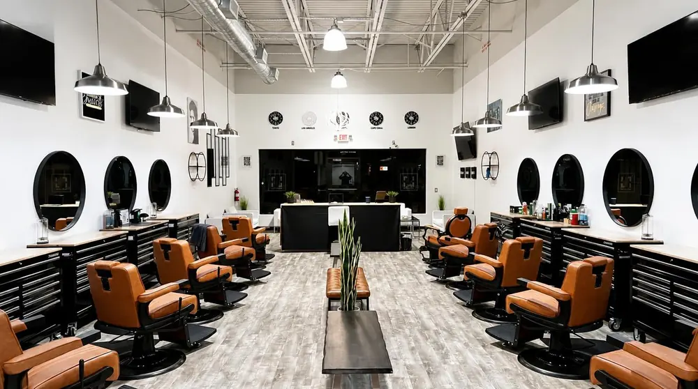 The main floor: cognac leather chairs and round LED-ring mirrors
