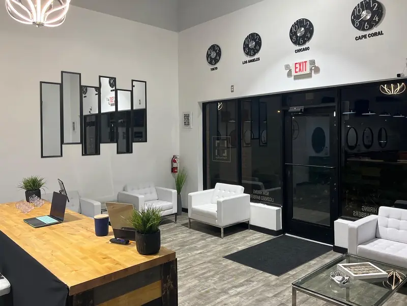 The waiting lounge with white sofas and the reception desk